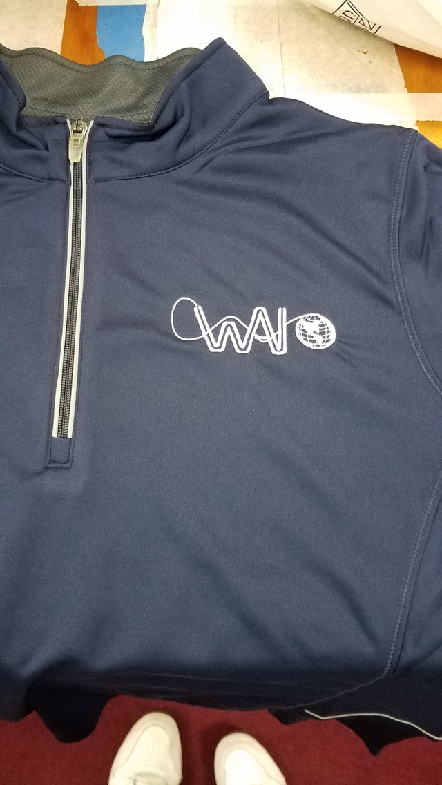 Embroidered logo on a navy quarter-zip
