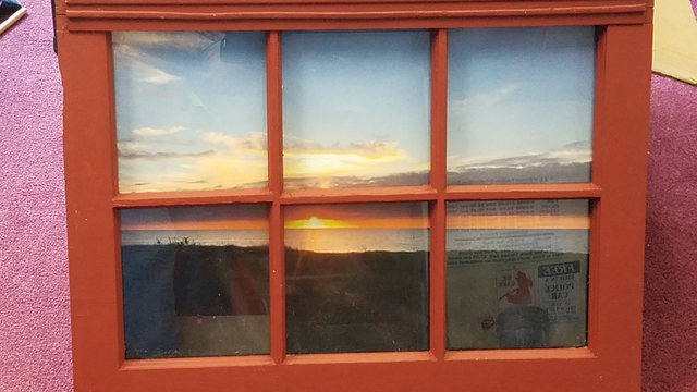 Sunset photograph mounted in a vintage window frame